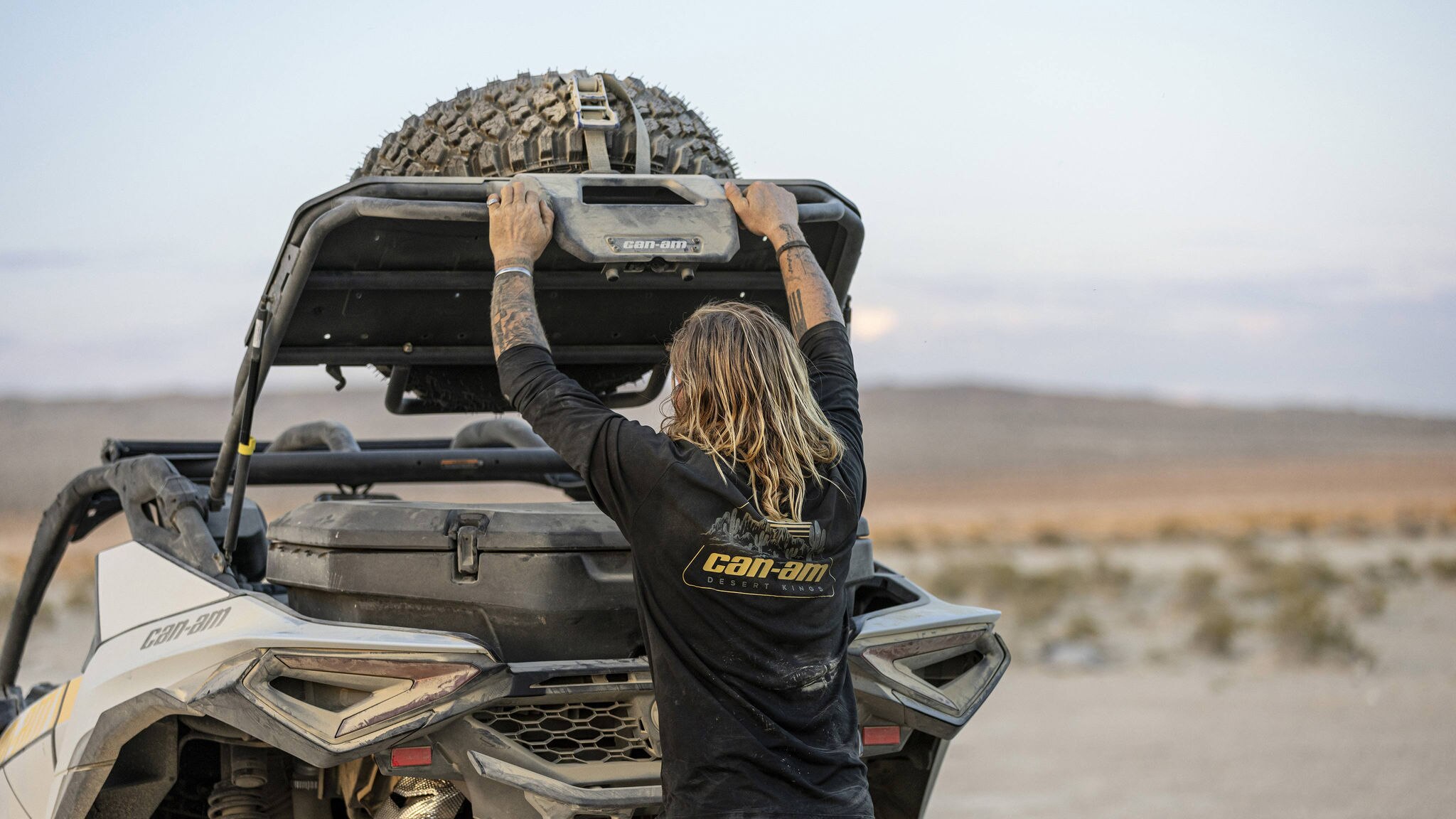 Terry Madden, embajador de Can-Am, levanta el maletero de su Maverick R SxS para acceder a la caja de carga LinQ.