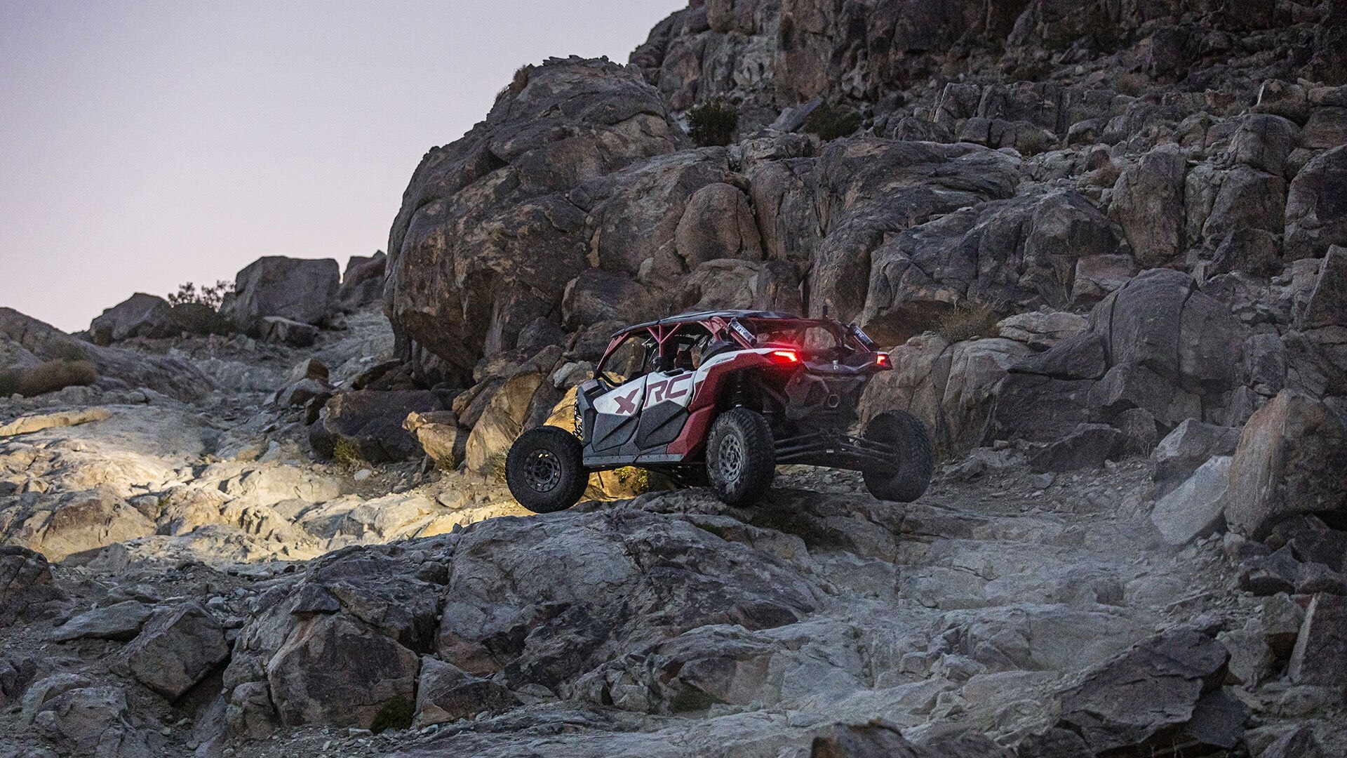 2024 Can-Am Maverick X3 SxS climbing a rocky hill