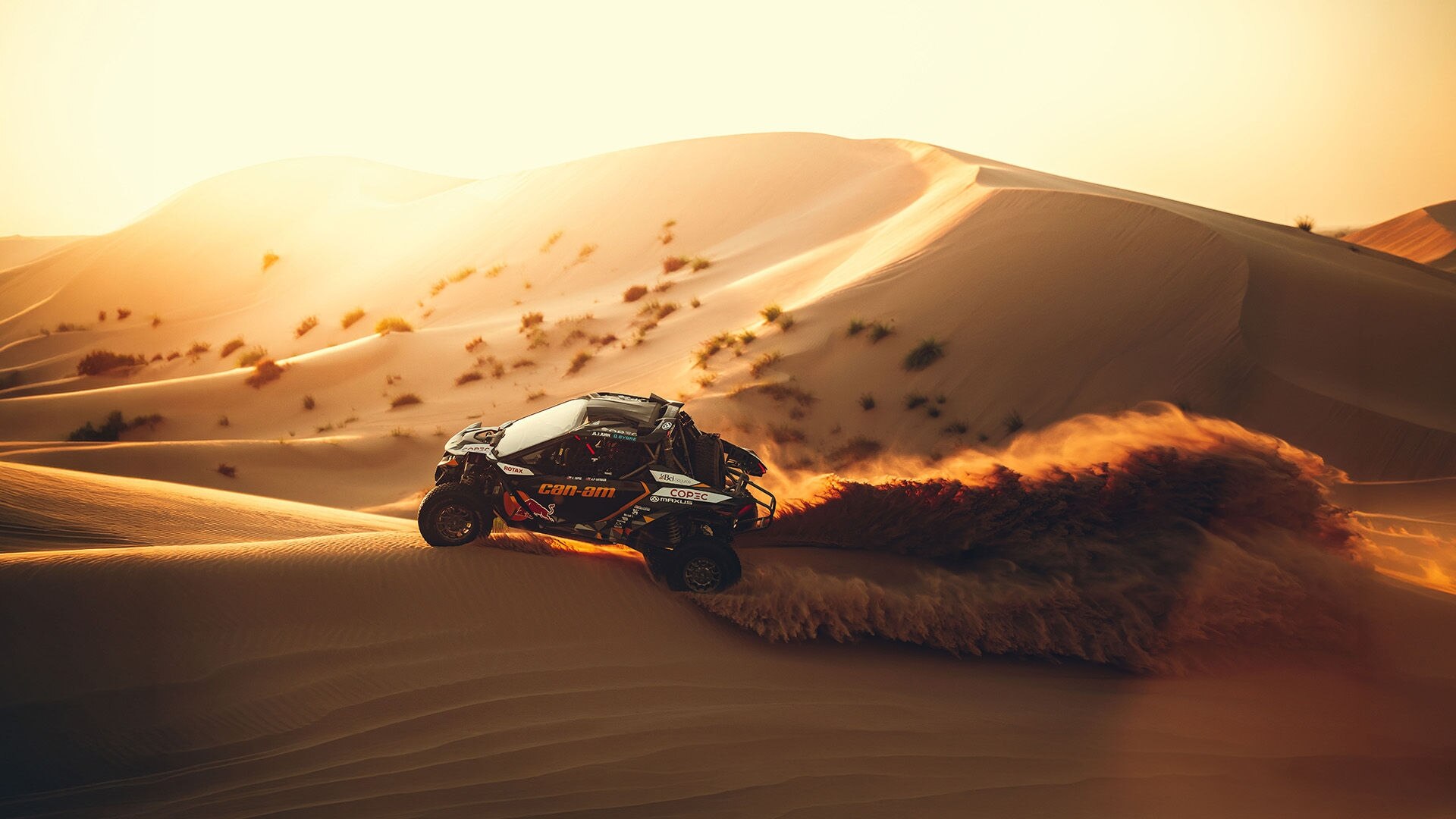 A Can-Am side-by-side racing across the dunes of the Dakar Rally