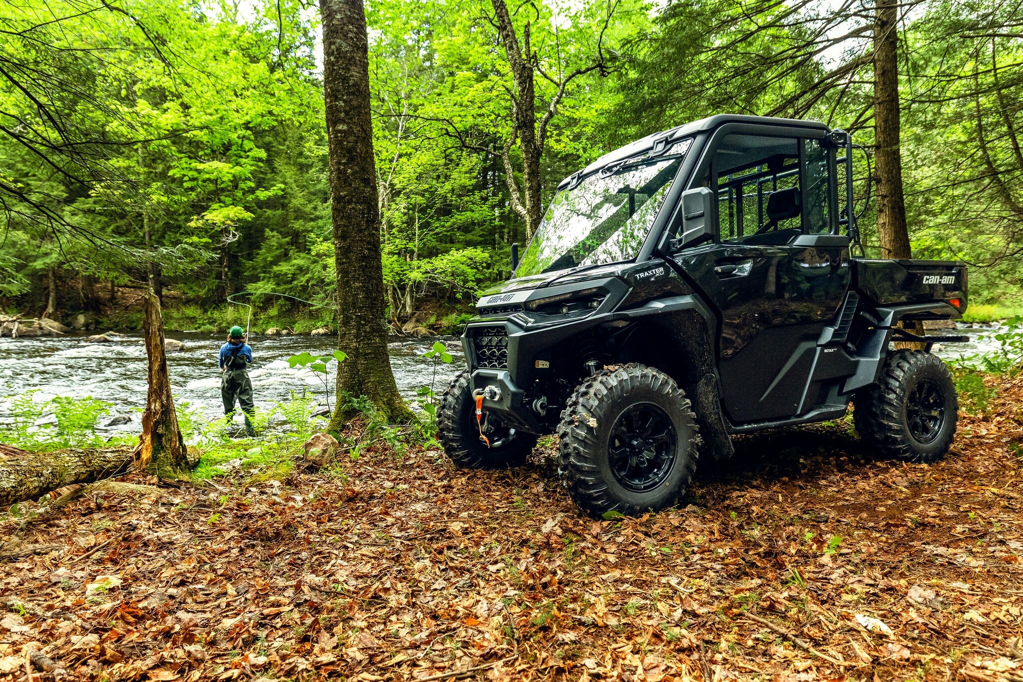 Traxter XU HD11 ABS in forest near a river