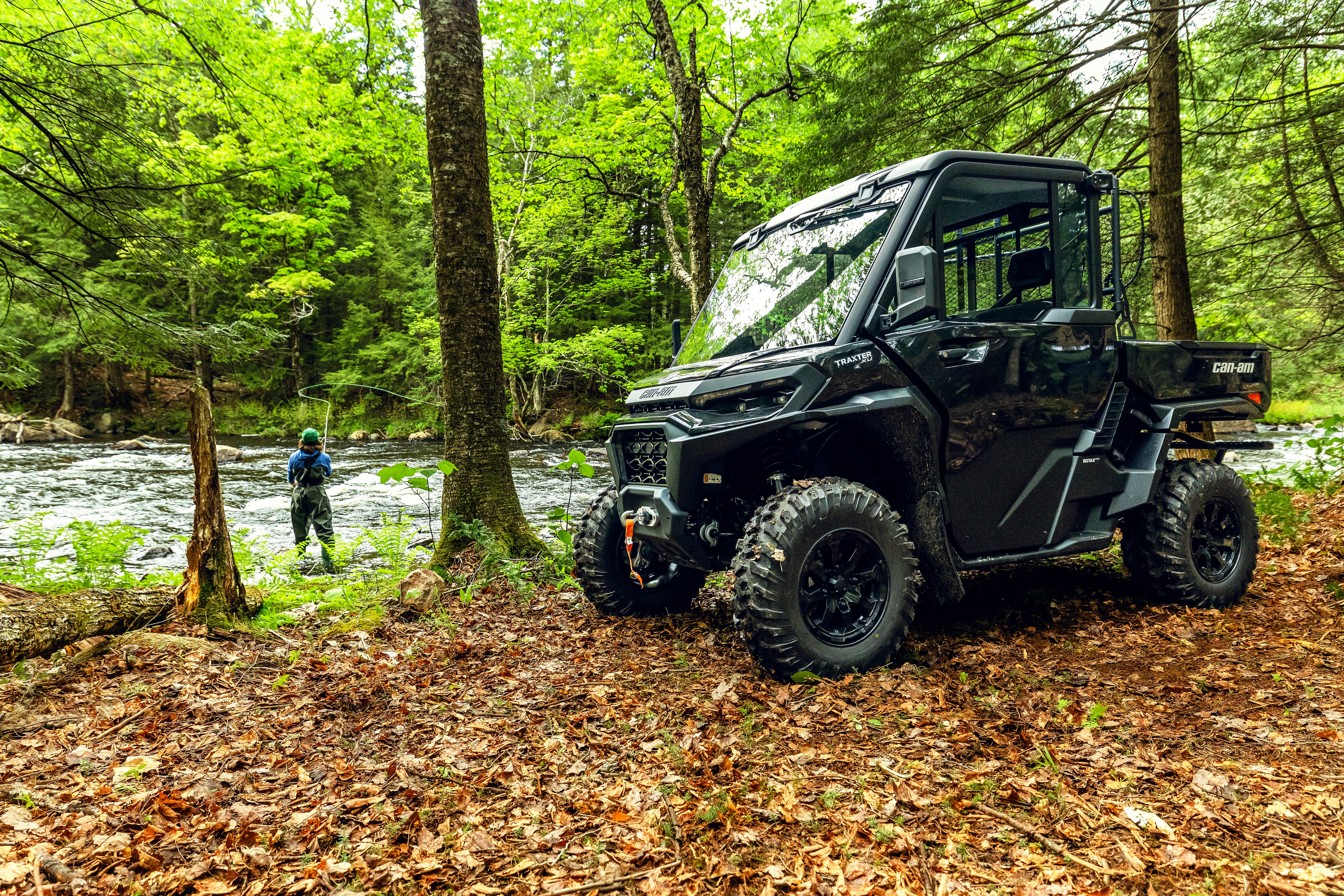 Traxter XU HD11 ABS in forest near a river