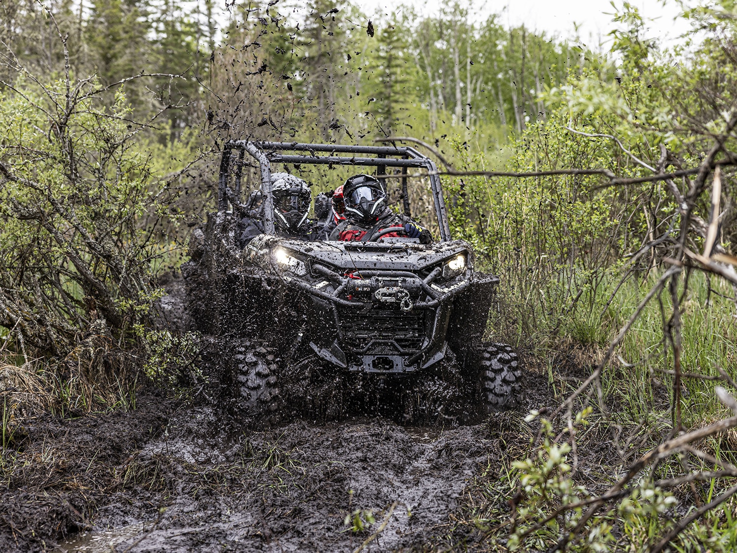 Can-Am Commander MAX X MR SxS vehicle riding in deep mud