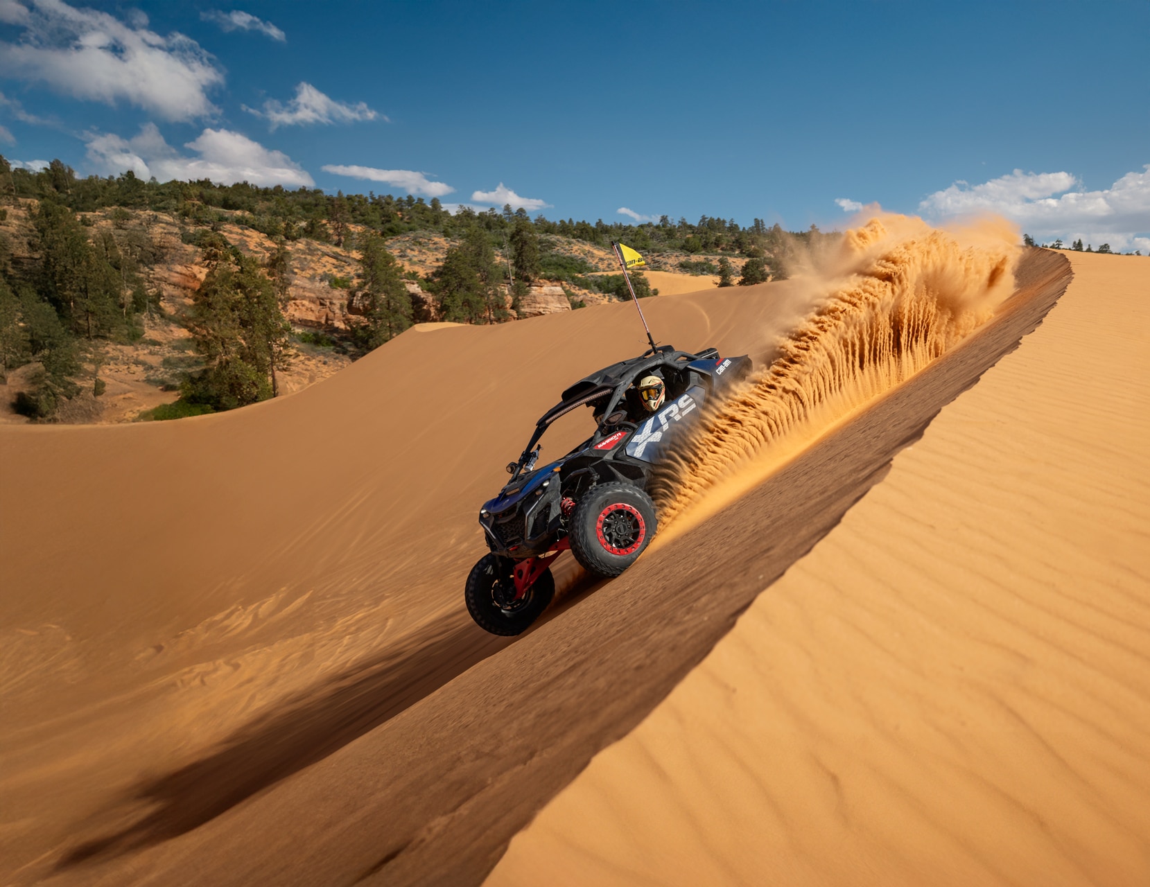 A 2026 Can-Am Maverick X RS rolling in the desert sand