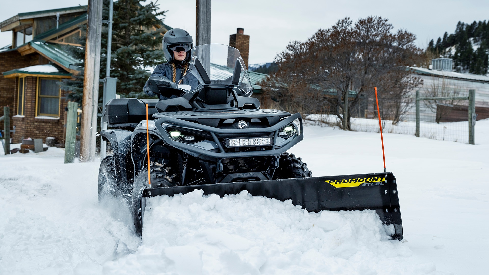 Woman plowing snow with a Can-Am Outlander ATV