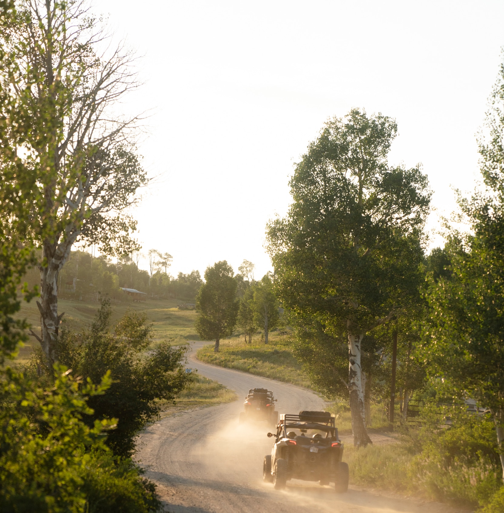 Two Can-Am Off-Road Vehicle driving down a beaten path
