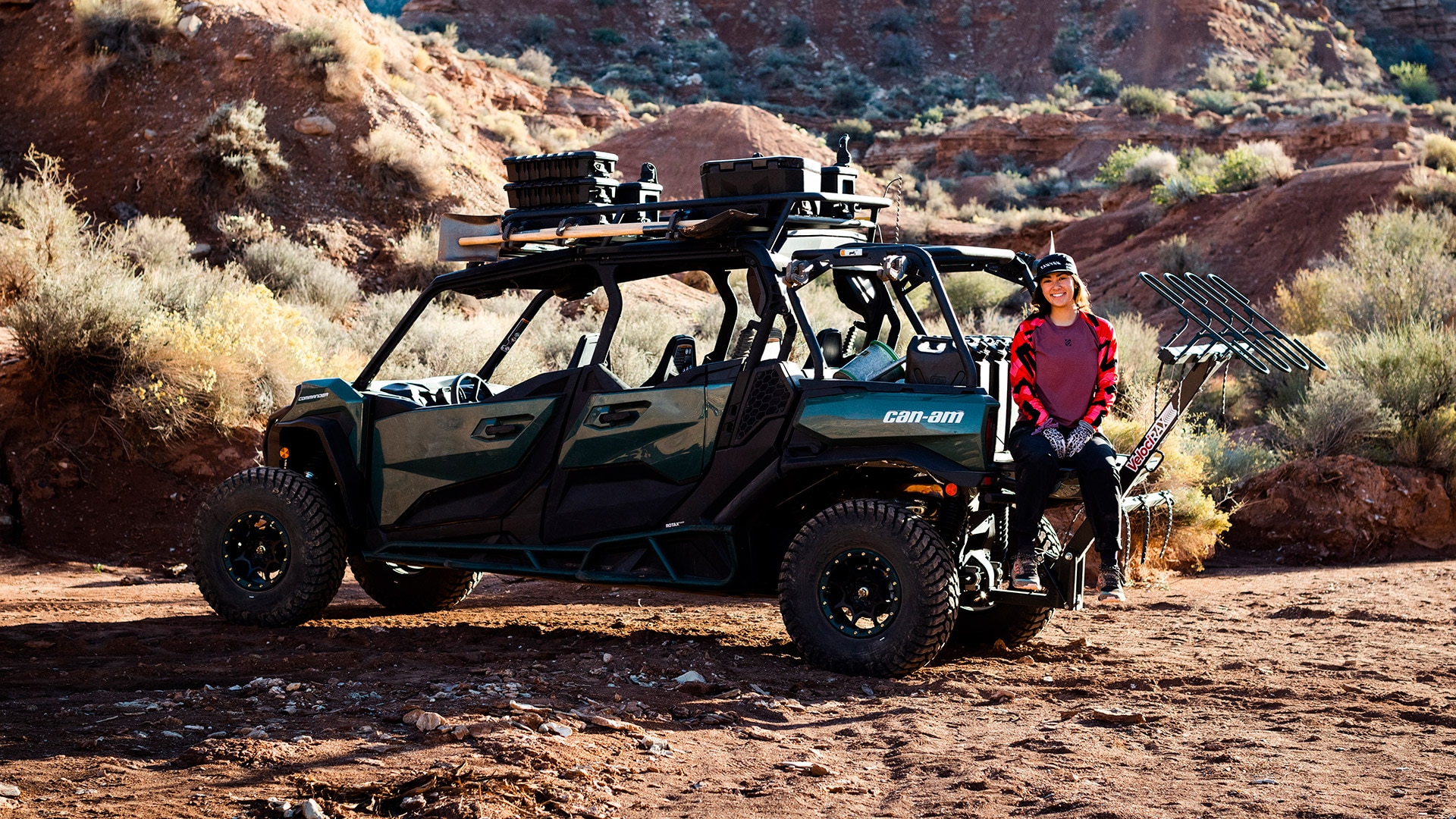 Samantha Soriano locking some trail building tools to the roof of her Can-Am Commander Max Side-by-side