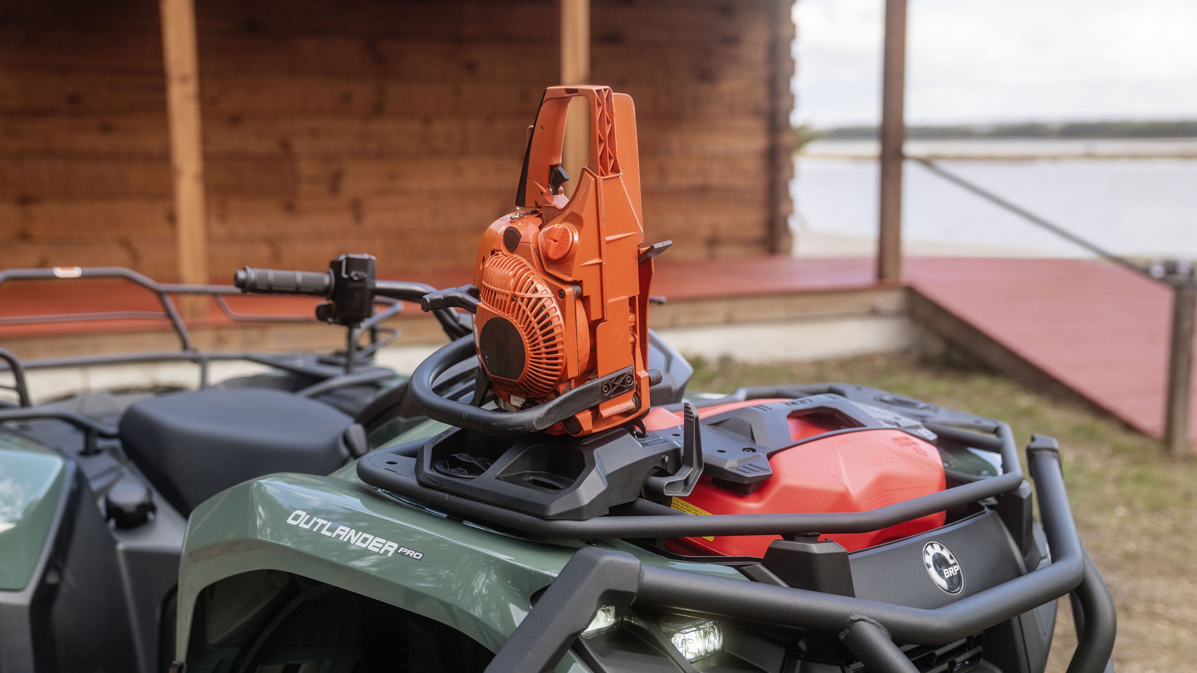 Quad vehicle with chainsaw mount accessory